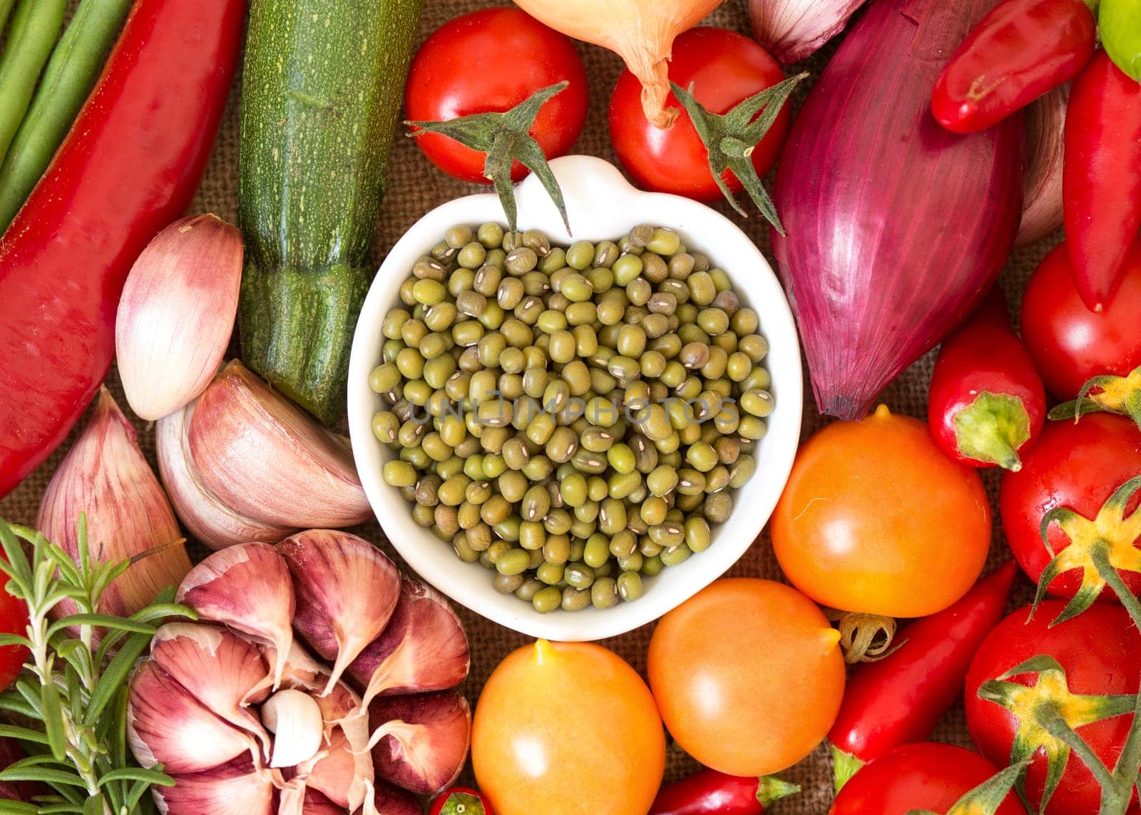 Dry organic mung beans in a bowl and vegetables