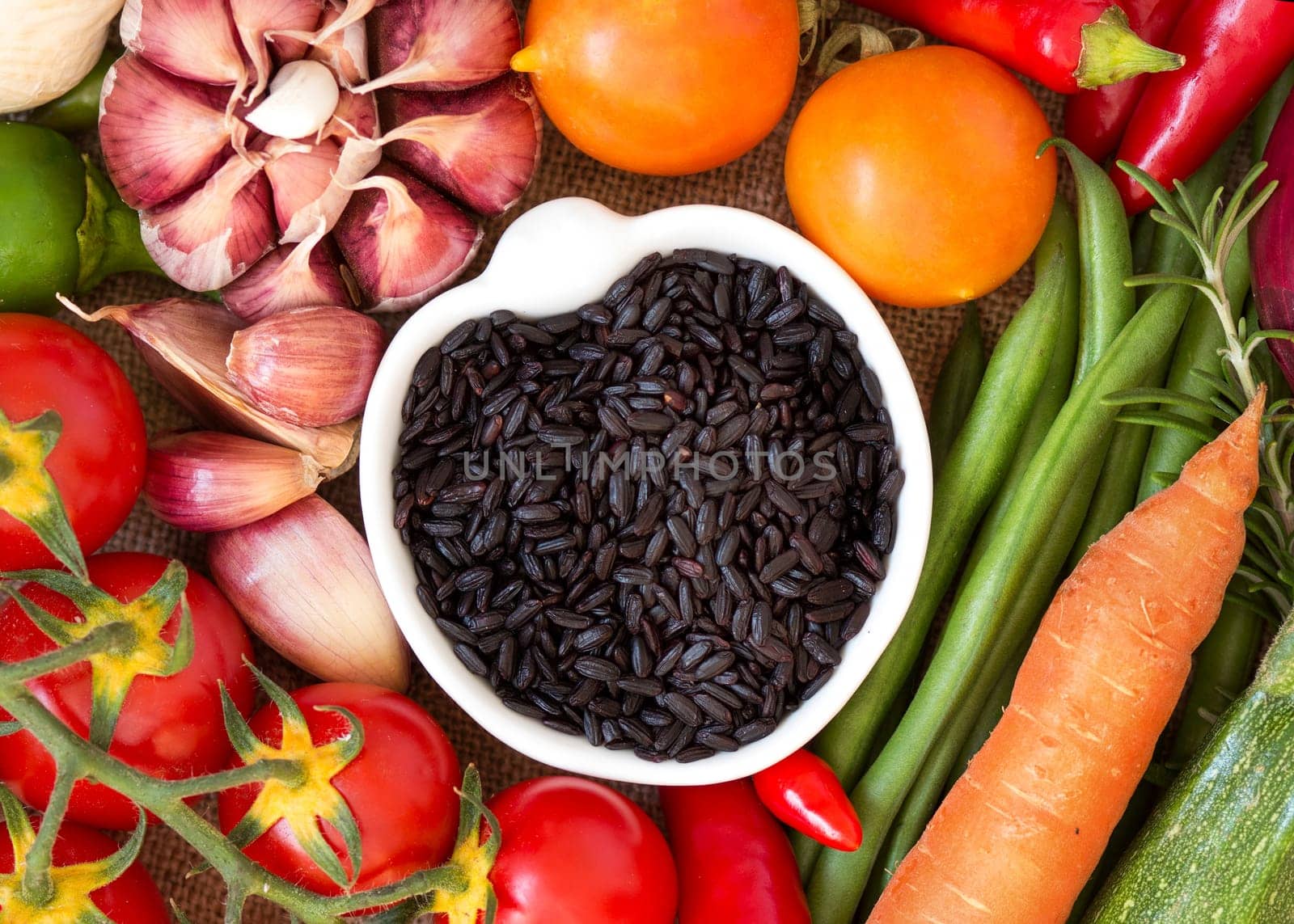 Black organic rice in bowl and vegetables
