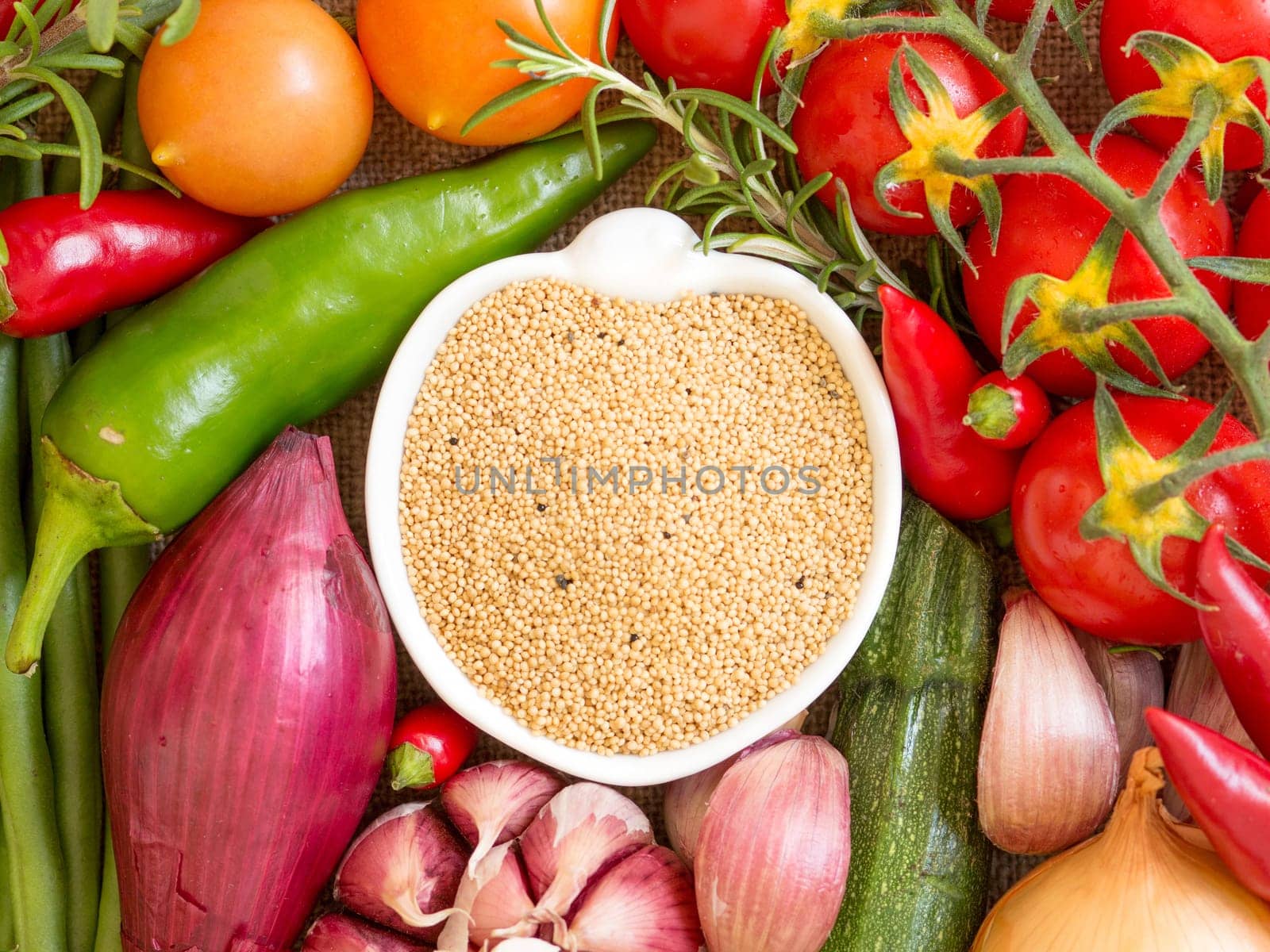 Raw organic amaranth in a bowl and vegetables