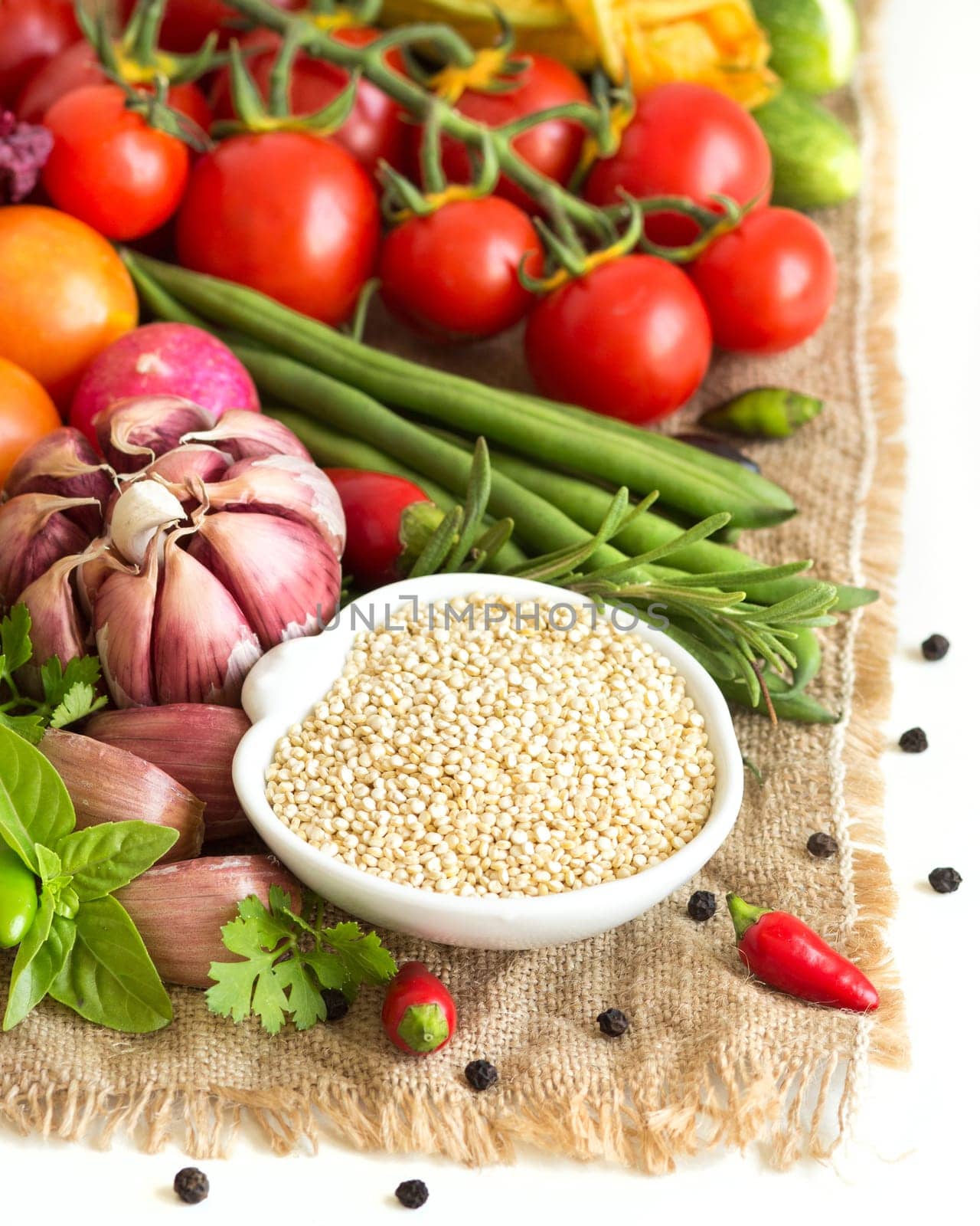 Raw organic quinoa in a bowl and vegetables