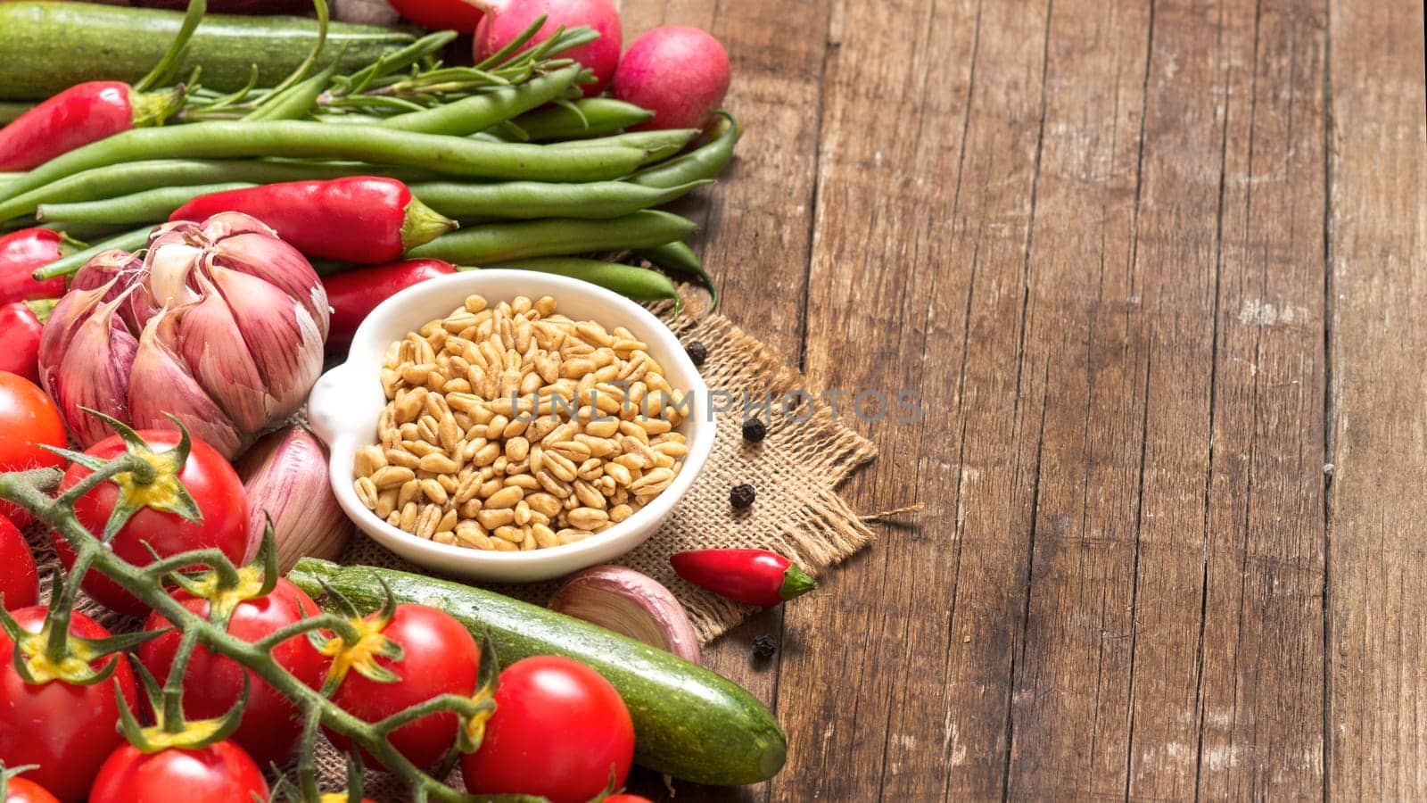 Whole wheat in a bowl and vegetables