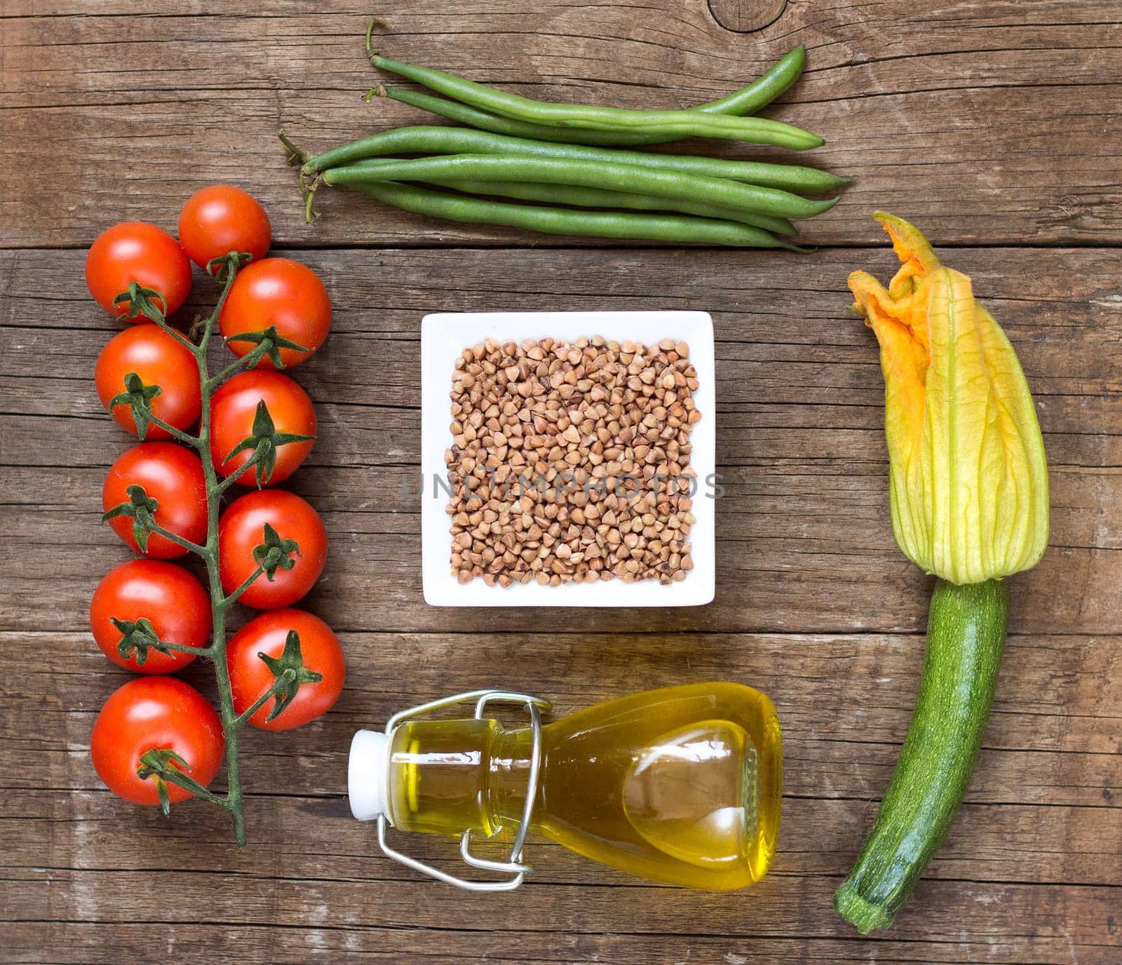 Raw Organic buckwheat and vegetables on wooden table