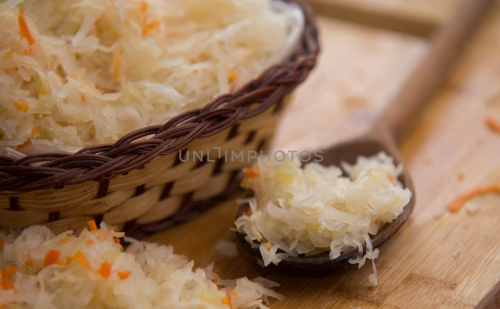 sauerkraut in a bowl on wooden plate