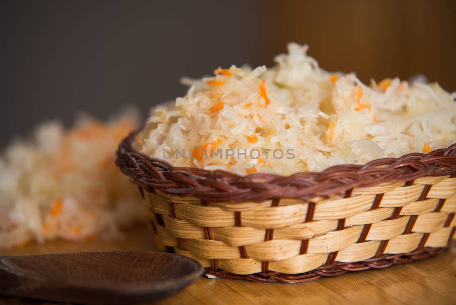 sauerkraut in bowl on wooden plate