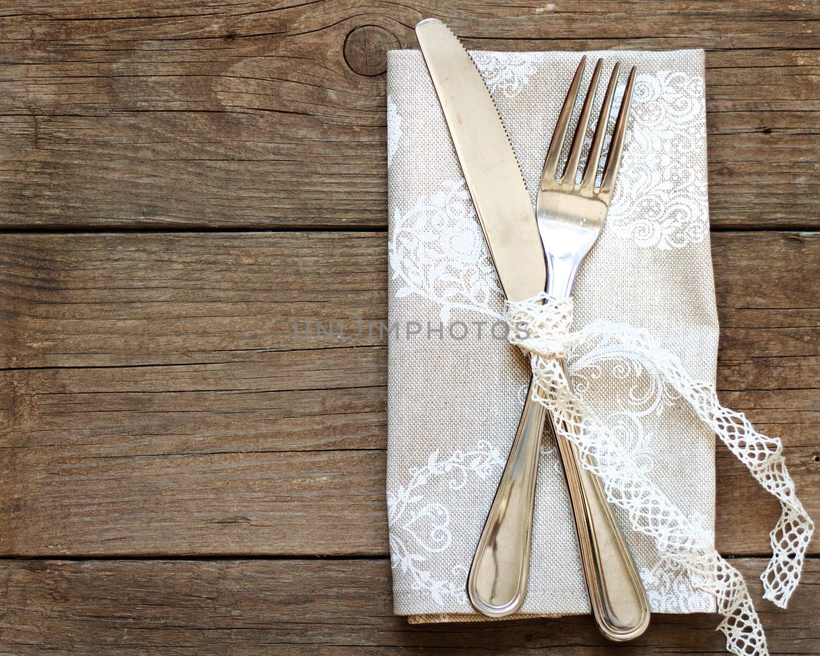 Rustic Table setting with vintage lace ribbon on old wooden table