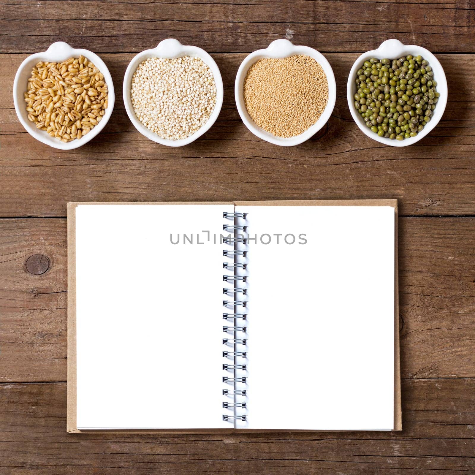 Raw Organic Amaranth and quinoa grains, wheat and mung beans in small bowls