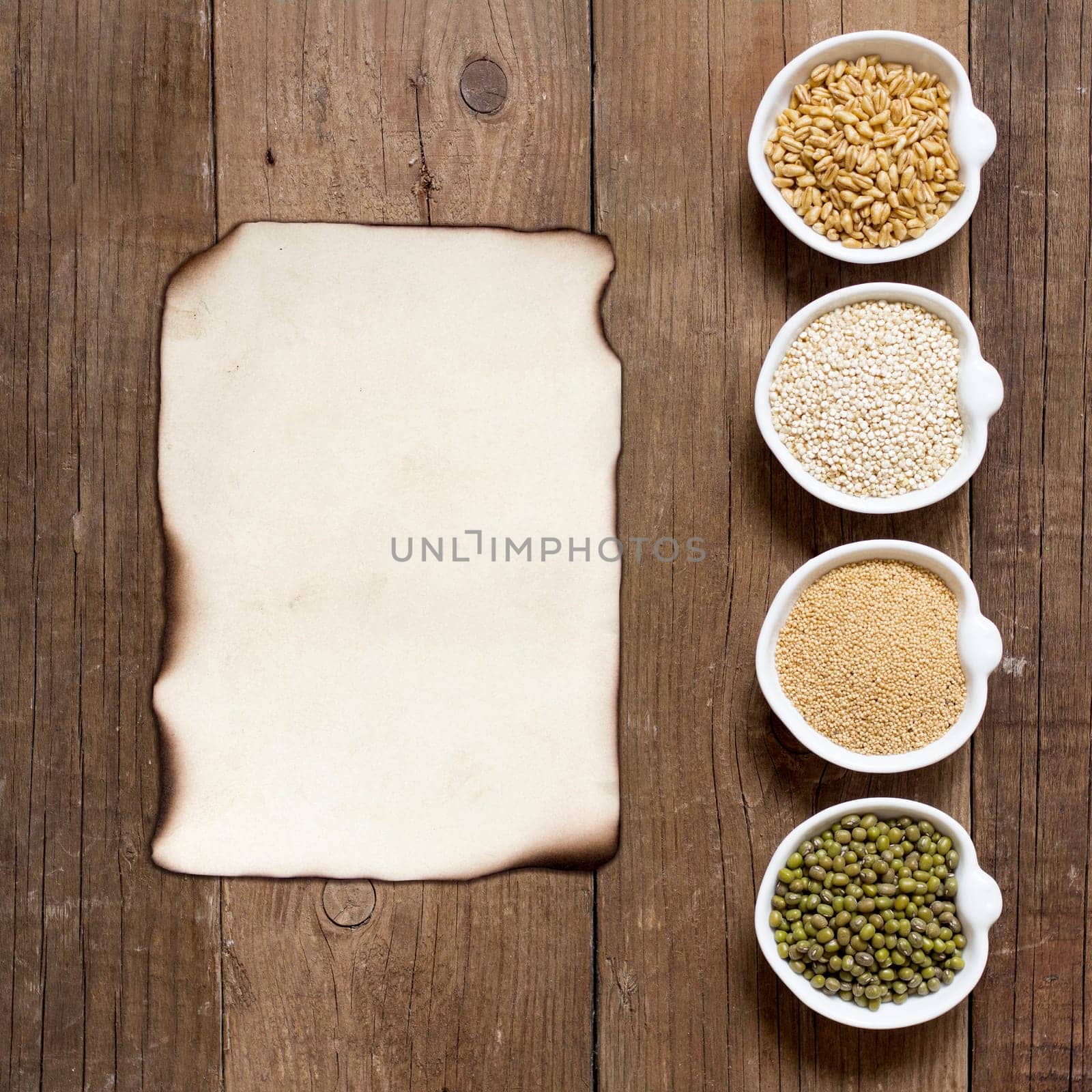 Raw Organic Amaranth and quinoa grains, wheat and mung beans in small bowls