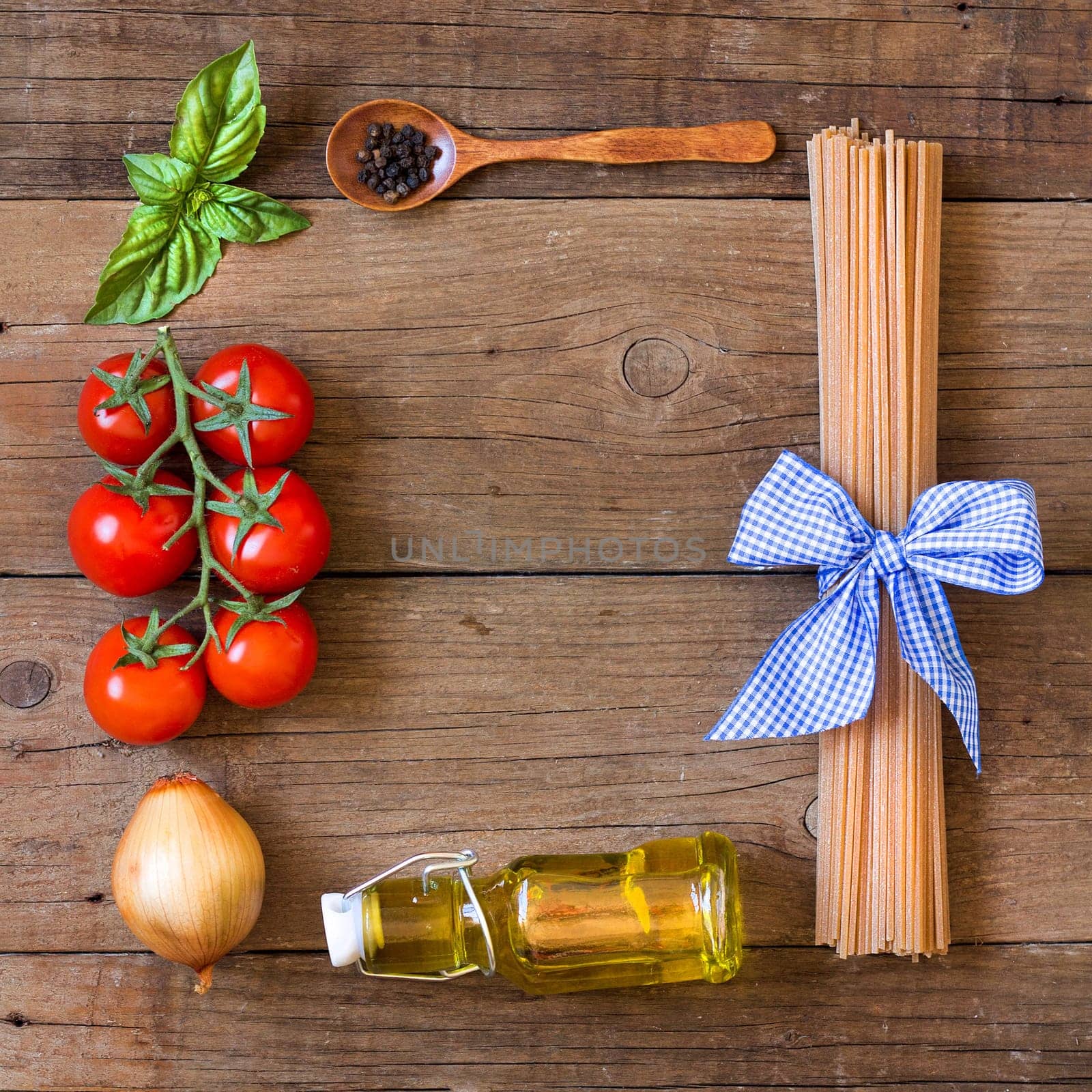 Ingridients for pasta with tomato sauce - tomatoes, onion, basil, extra vergin olive oil, pepper and whole durum spaghetti