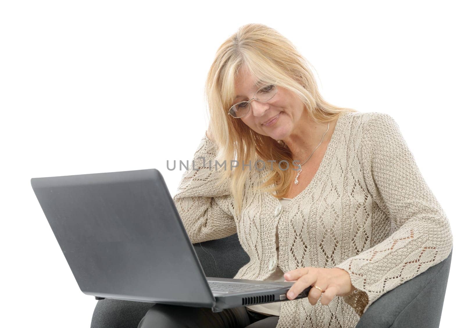 a portrait of a smiling mature woman using laptop