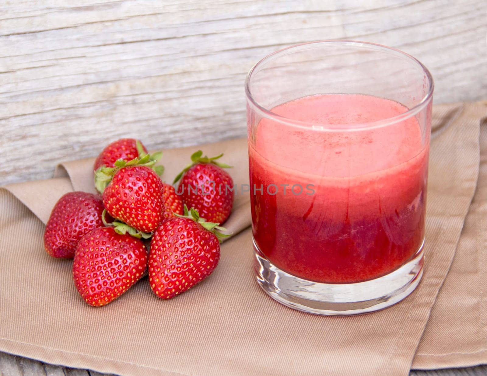 Fresh strawberry smoothie juice and strawberries