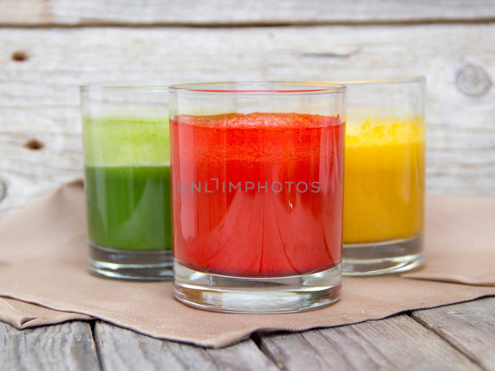 Fresh smoothies in the glass - green, red and yellow paprika