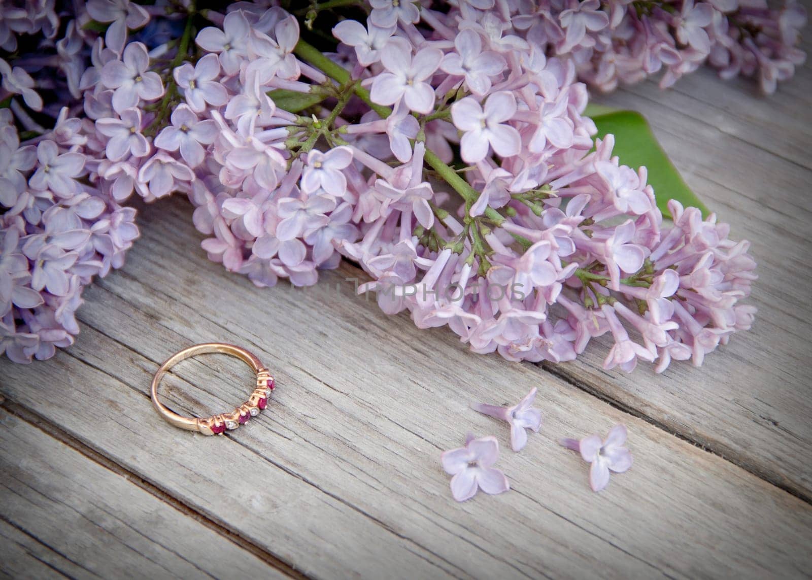 Ring and lilac on wood