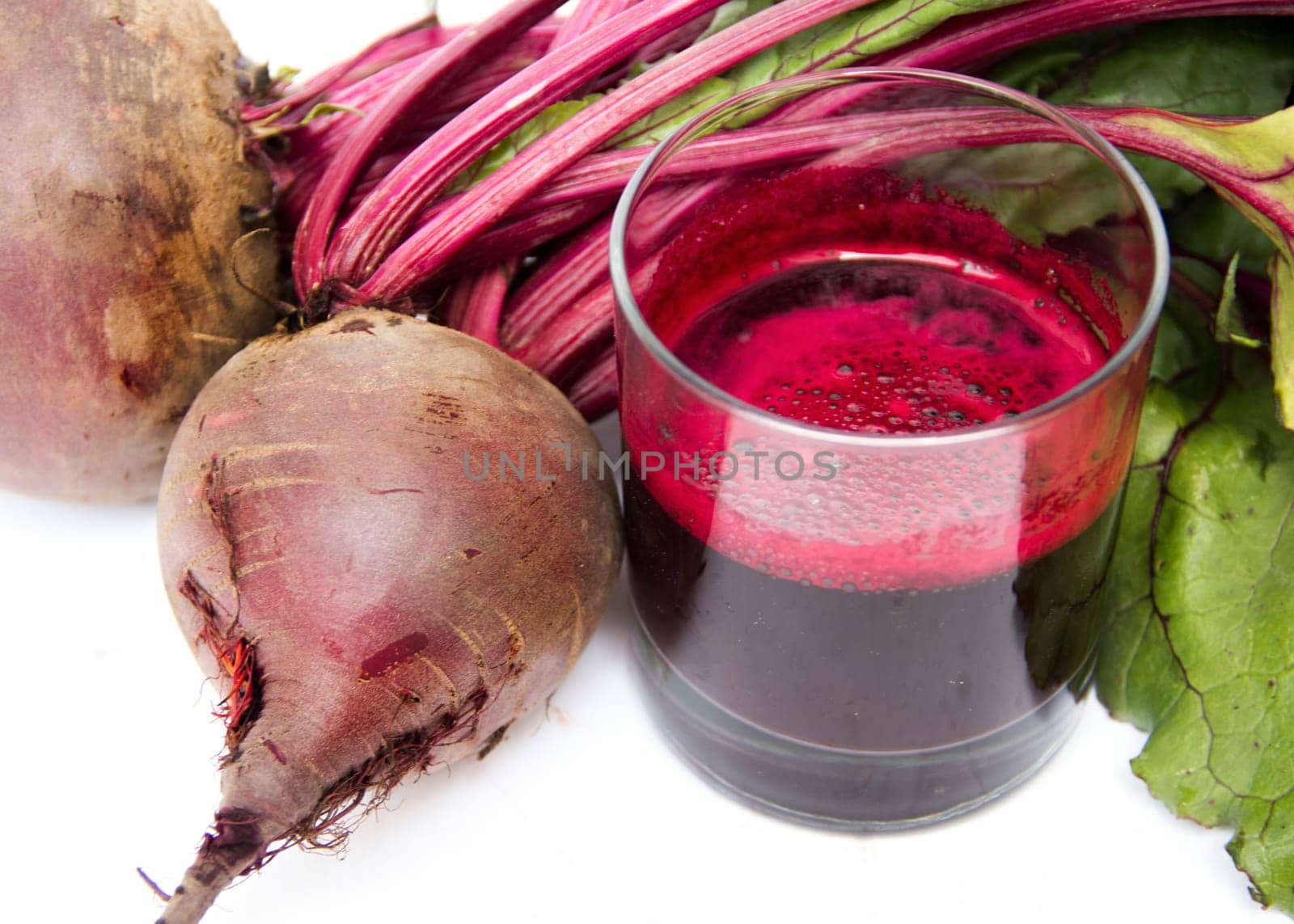 Fresh juice of red beets on white