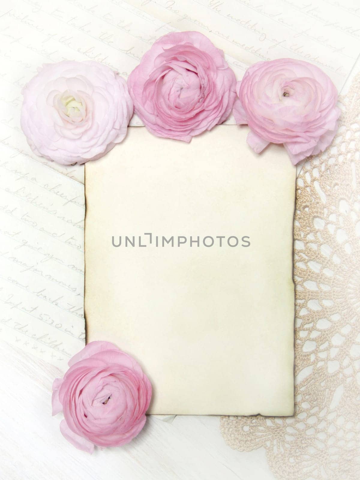 Ranunculus flowers, paper and heart background