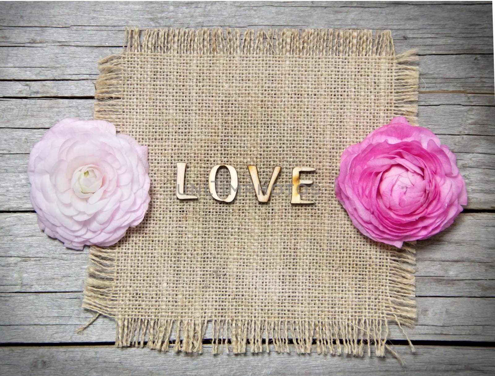 Ranunculus flowers and letters LOVE on wood