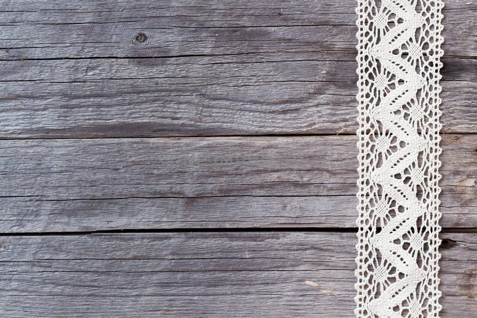 Lace on old wood background
