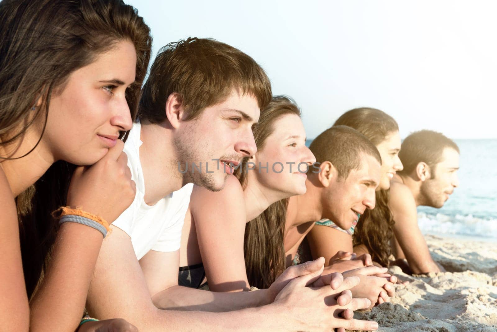 Group of happy teenage friends at the beach