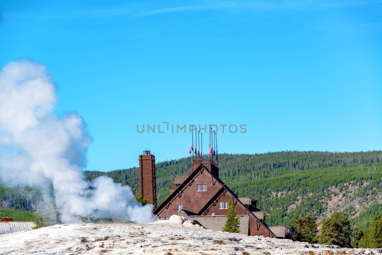 View of Old Faithful lodge and geyser at Yellowstone National Park