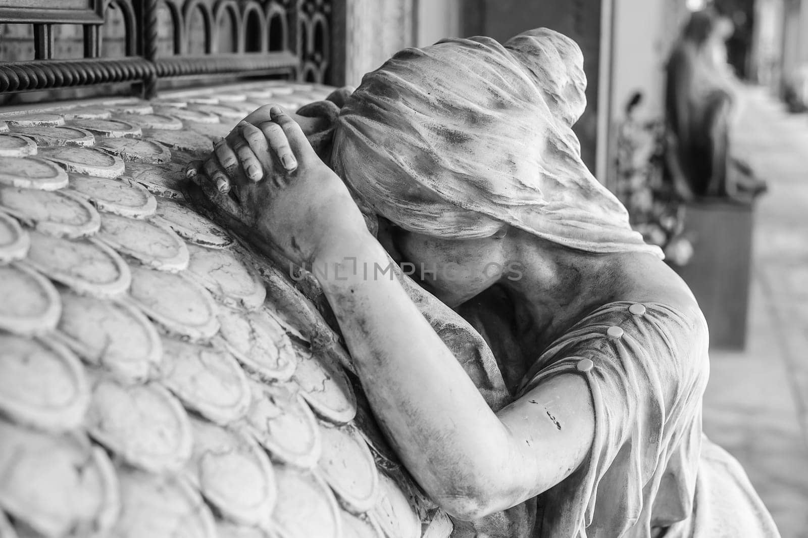 More than 100 years old statue. Cemetery located in North Italy. Black and white