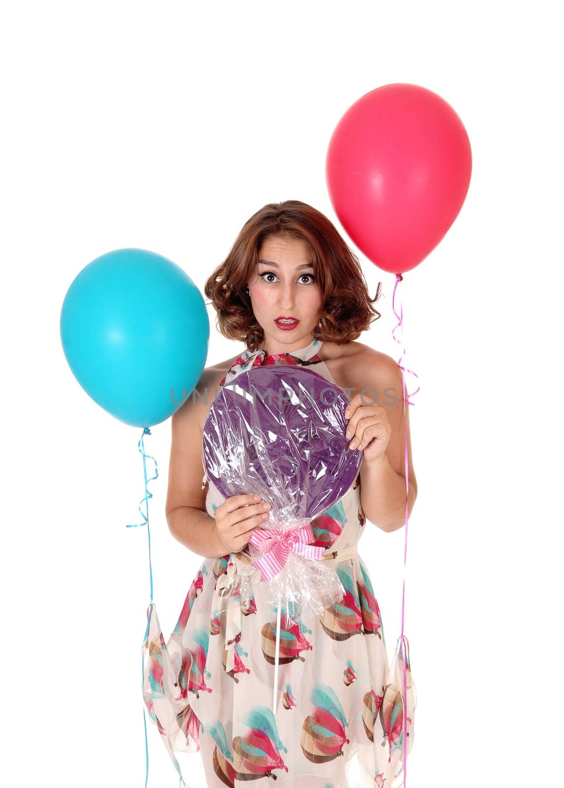 A closeup image of a gorgeous young woman with a big lollypop and.two balloons, isolated for white background..
