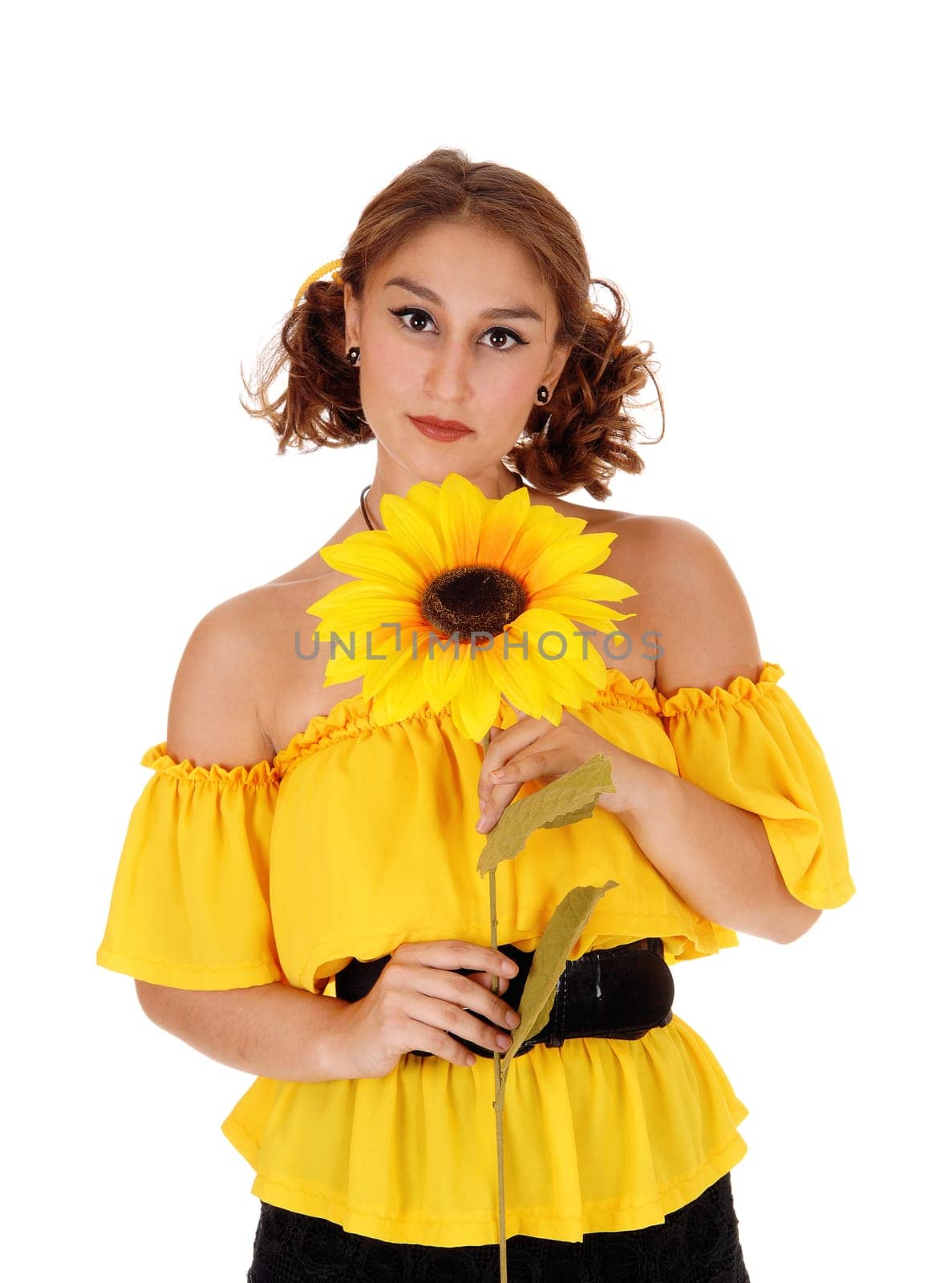 A portrait of a woman in a yellow blouse holding one sunflower,.standing isolated for white background..