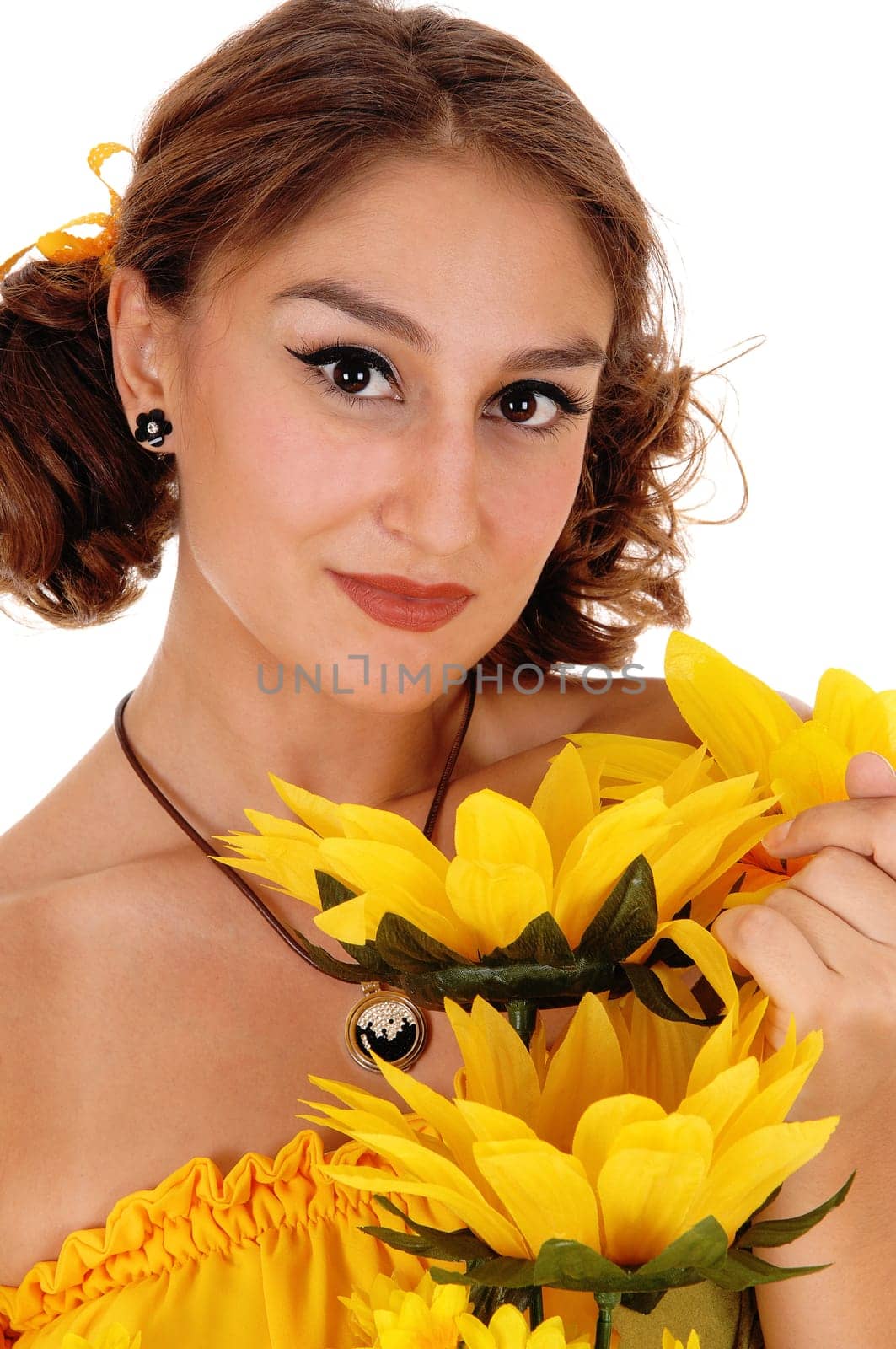 Gorgeous young woman in a yellow blouse holding a bunch of .sunflowers, smiling, standing isolated for white background..