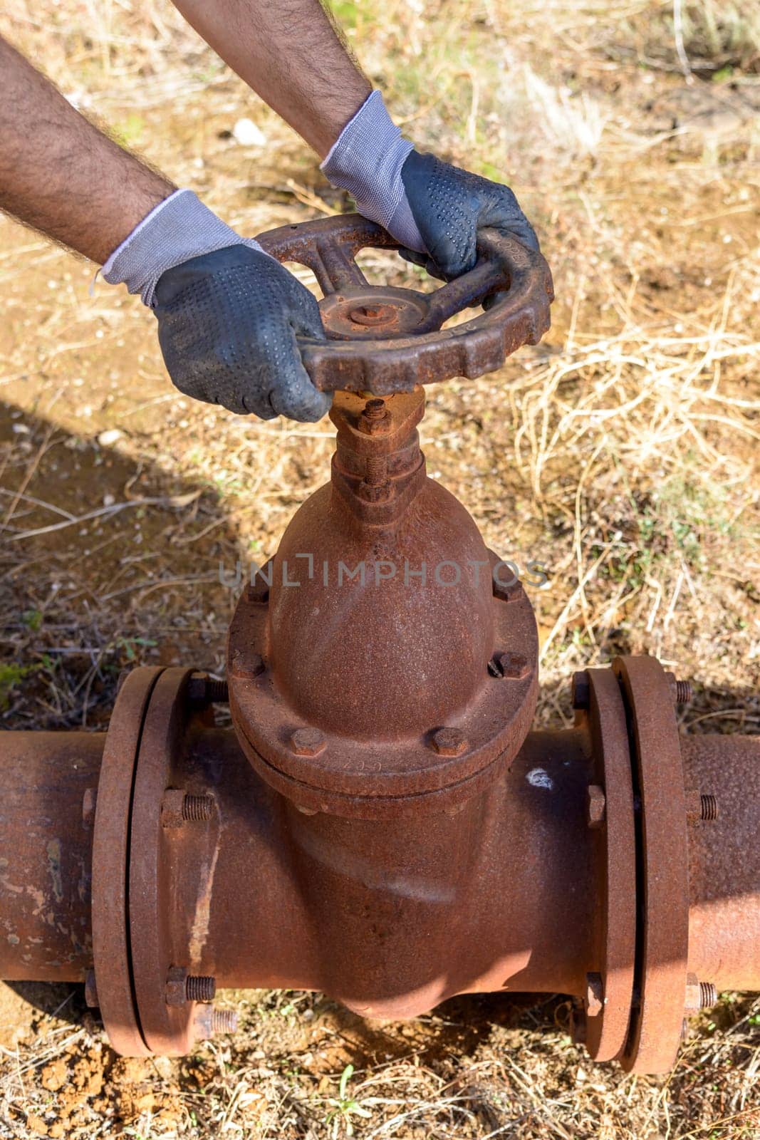 Workman at work in an old plumbing with equipment.