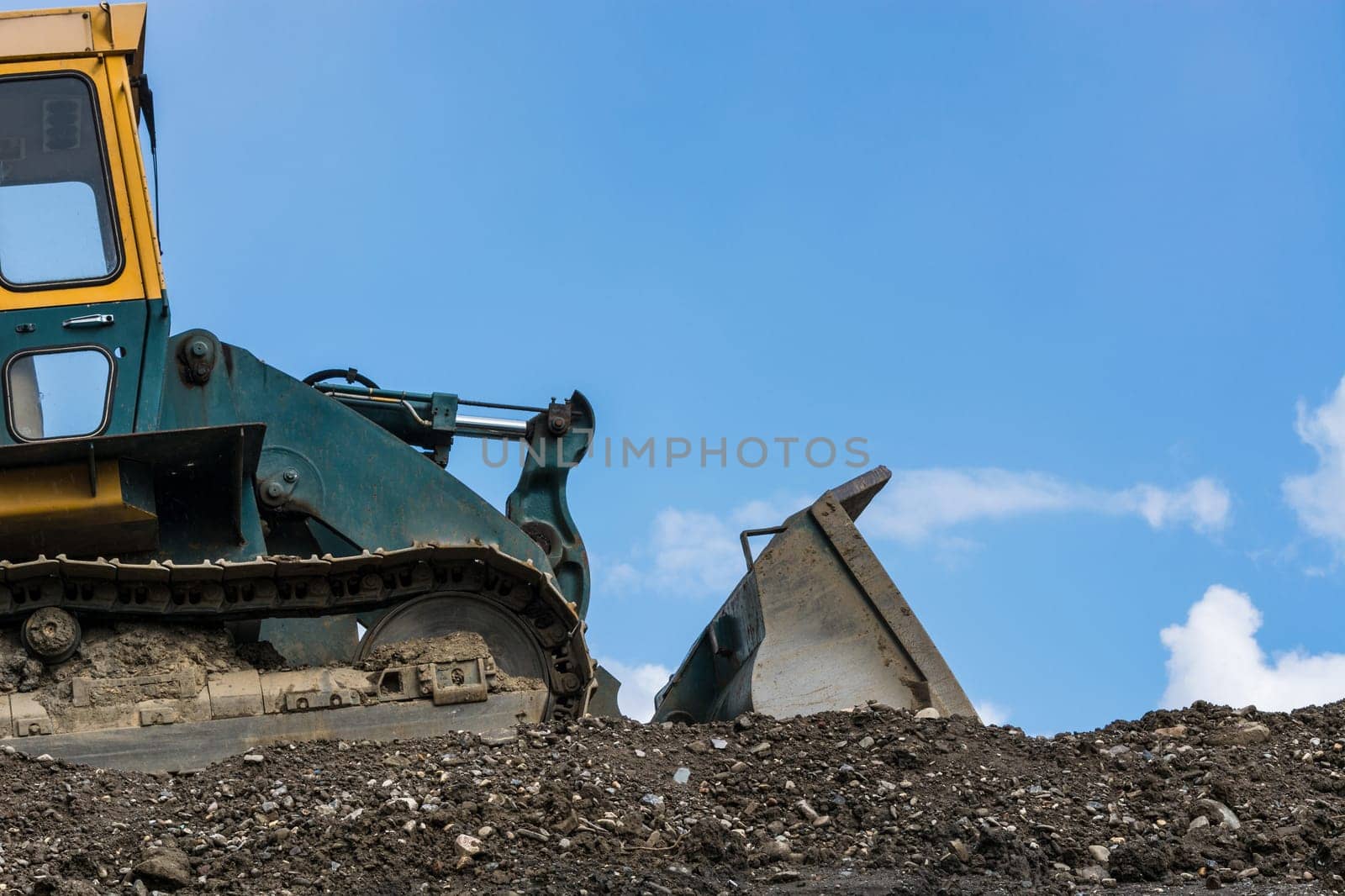 Construction machine on a construction site in the background a blue sky..