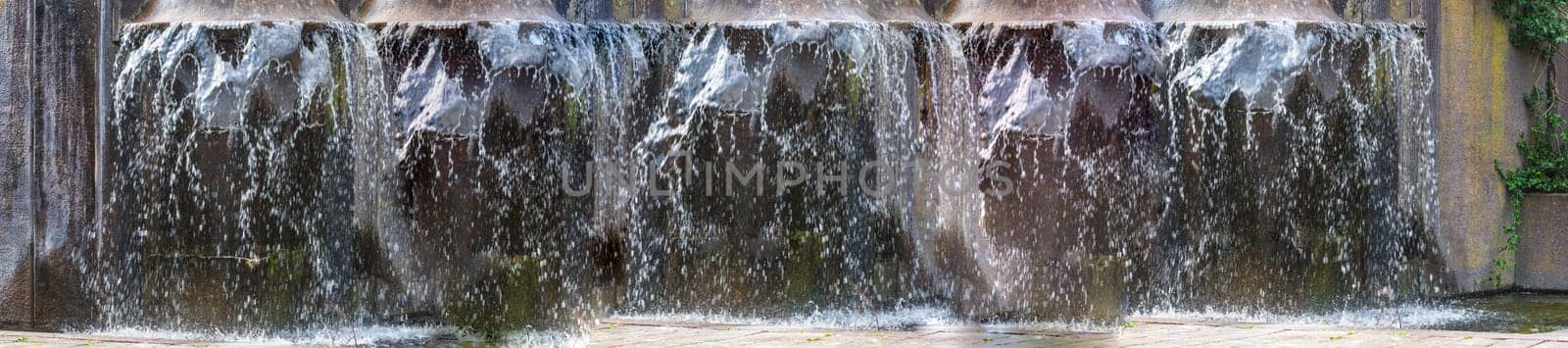 Panorama Artificially designed waterfall,fountain - fountain in a park..