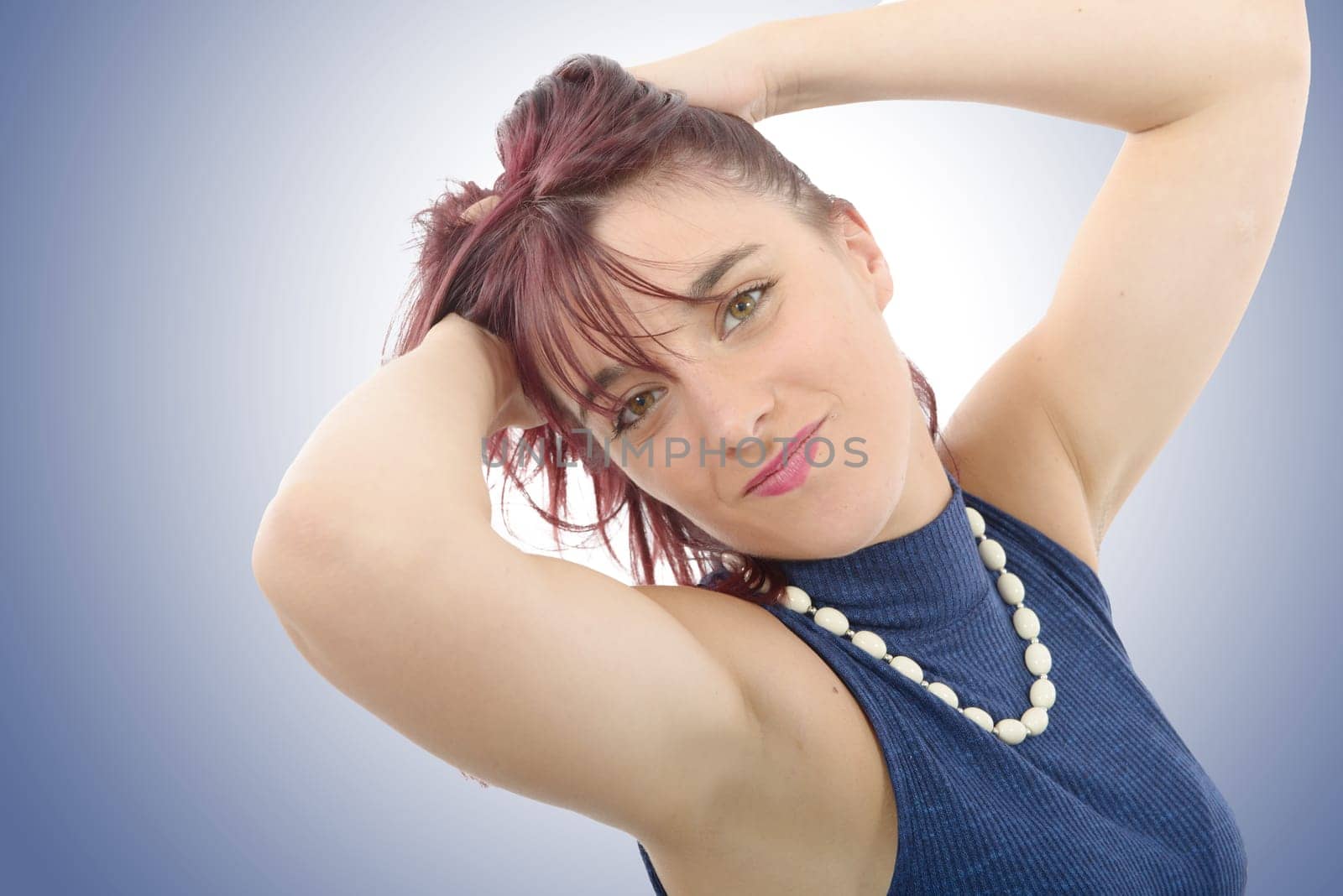 portrait of beautiful young woman with red hairs, blue background