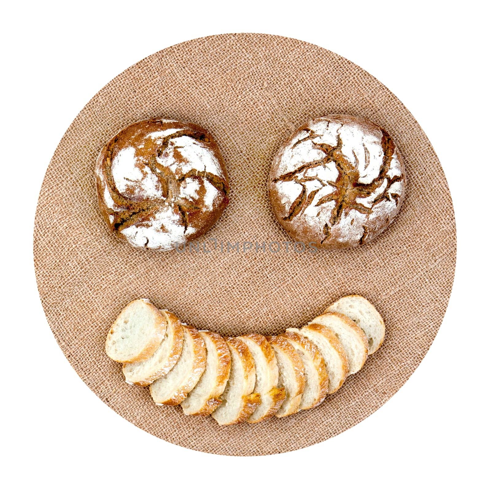Smiling emoticon with round bread and slices on hemp canvas representing diet healthy food