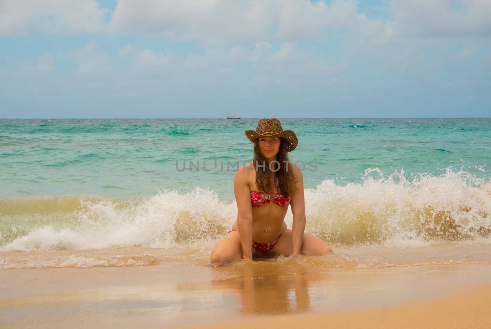 Free woman in hat enjoying freedom feeling happy at beach