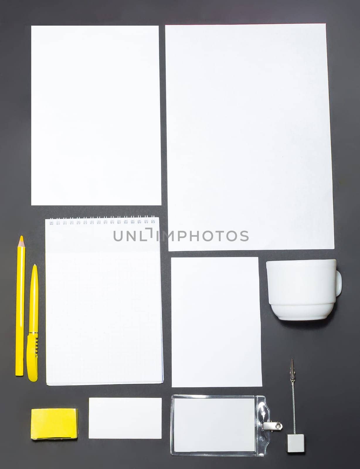 Mock-up business template with cards, papers, pen on gray background.