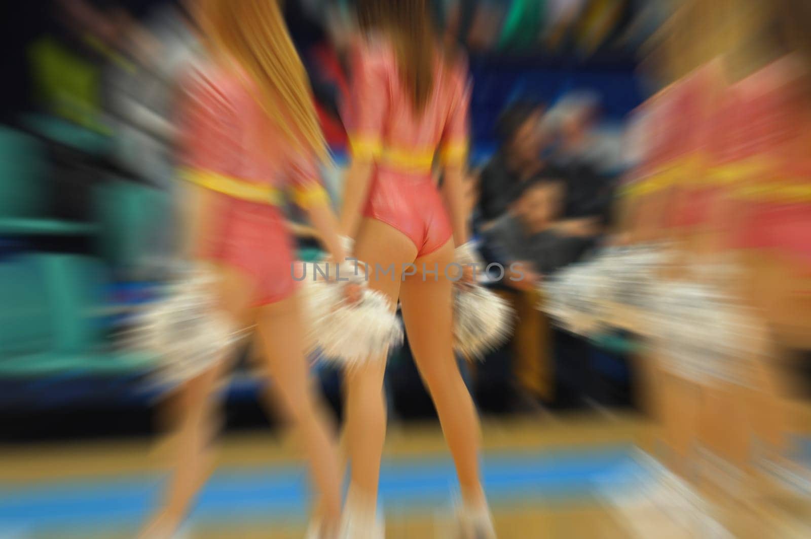 closeup of a young group of girls. cheerleaders performance at competitions,motion blur effect