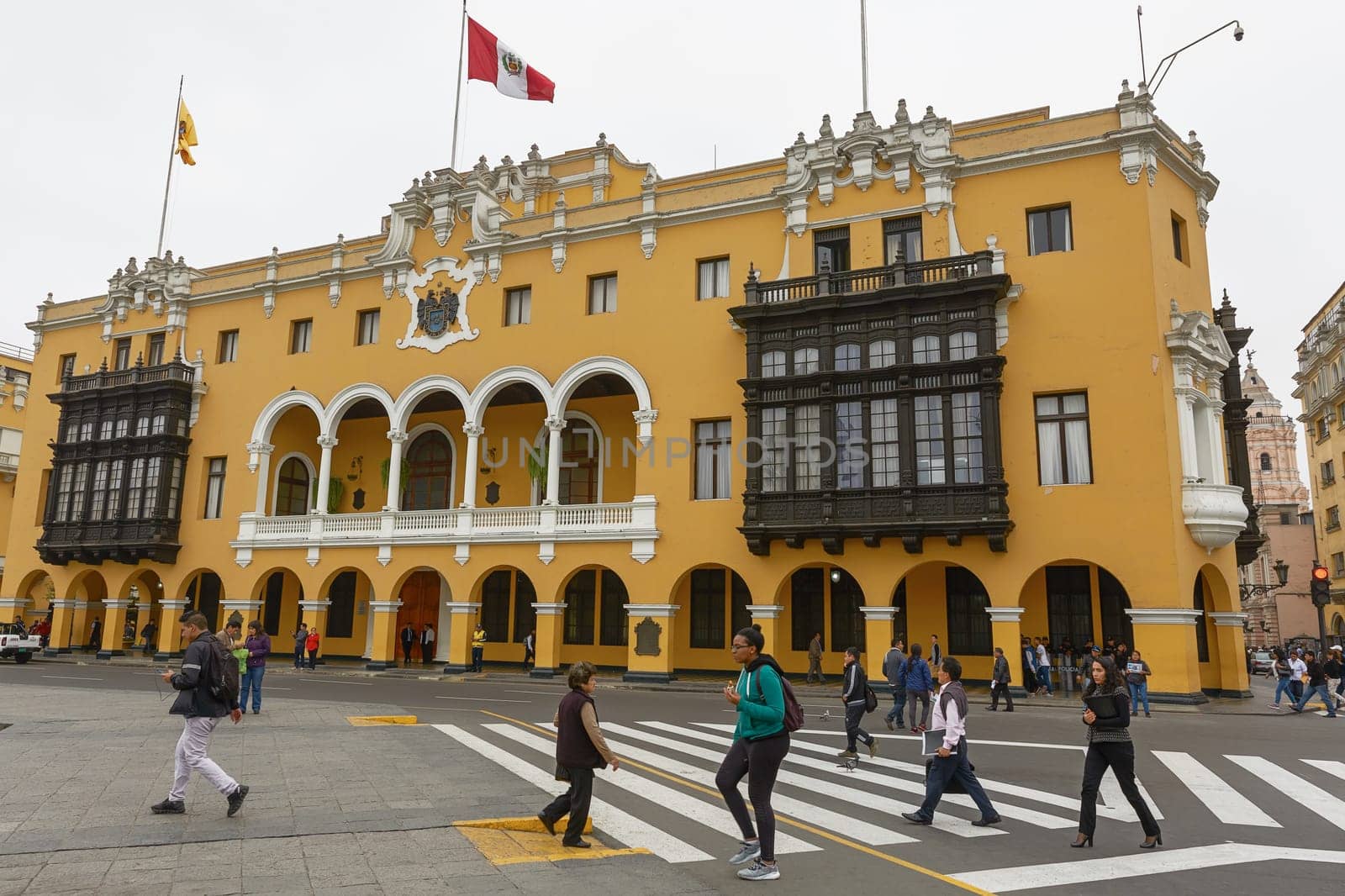 People and Tourists Crossing the Street at the Plaza Mayor in Lima, Peru.