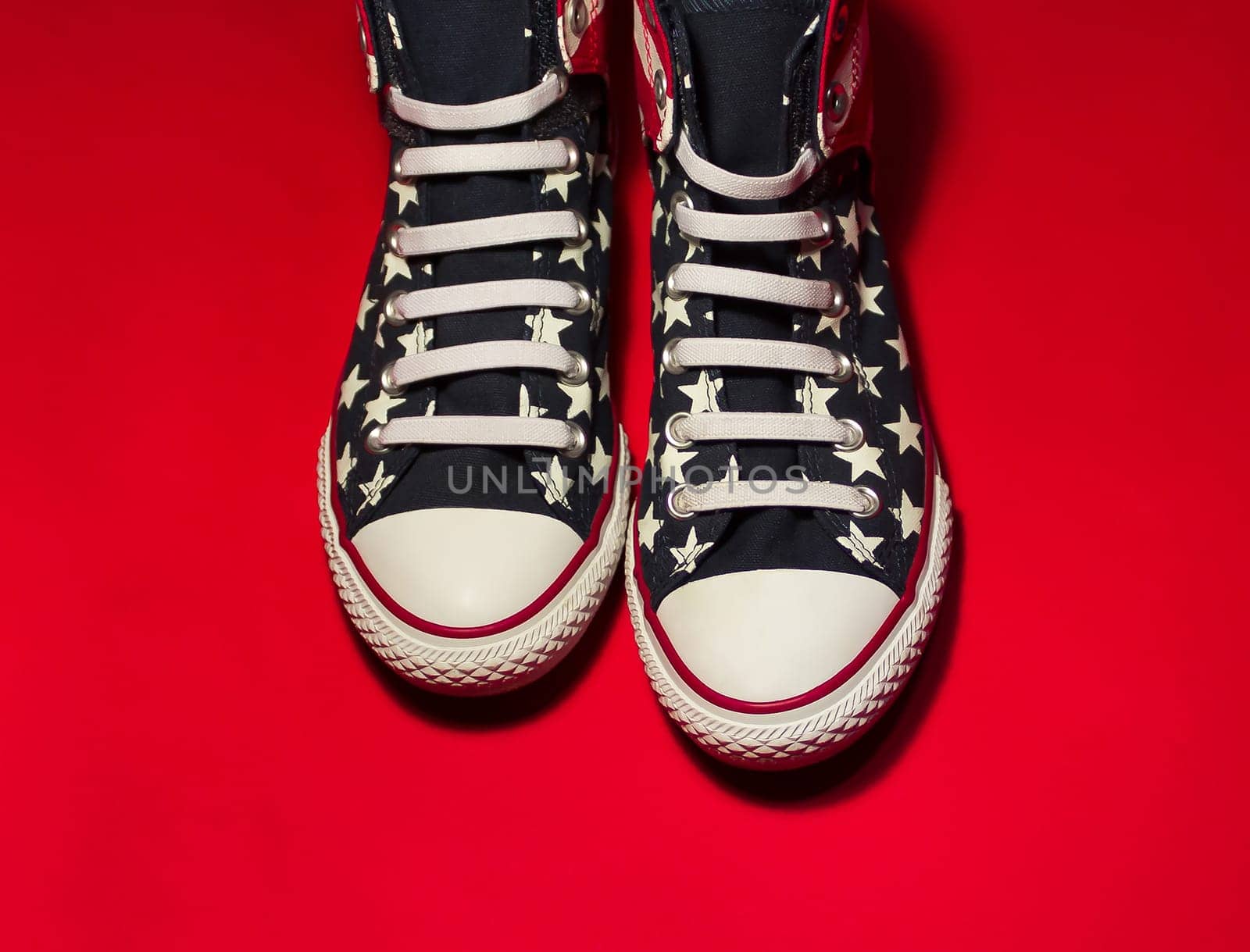 Dnipropetrovsk, Ukraine - May, 29 2016: All Star Converse sneakers on red background