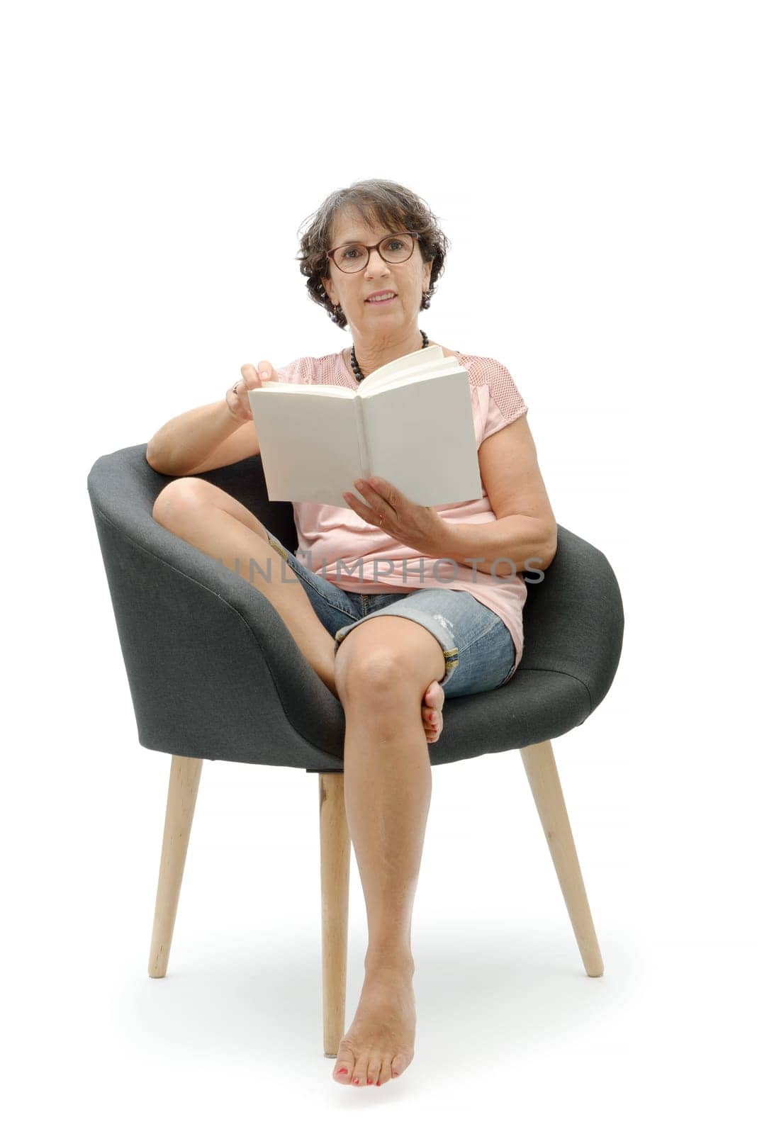 a mature brunette woman reading a book