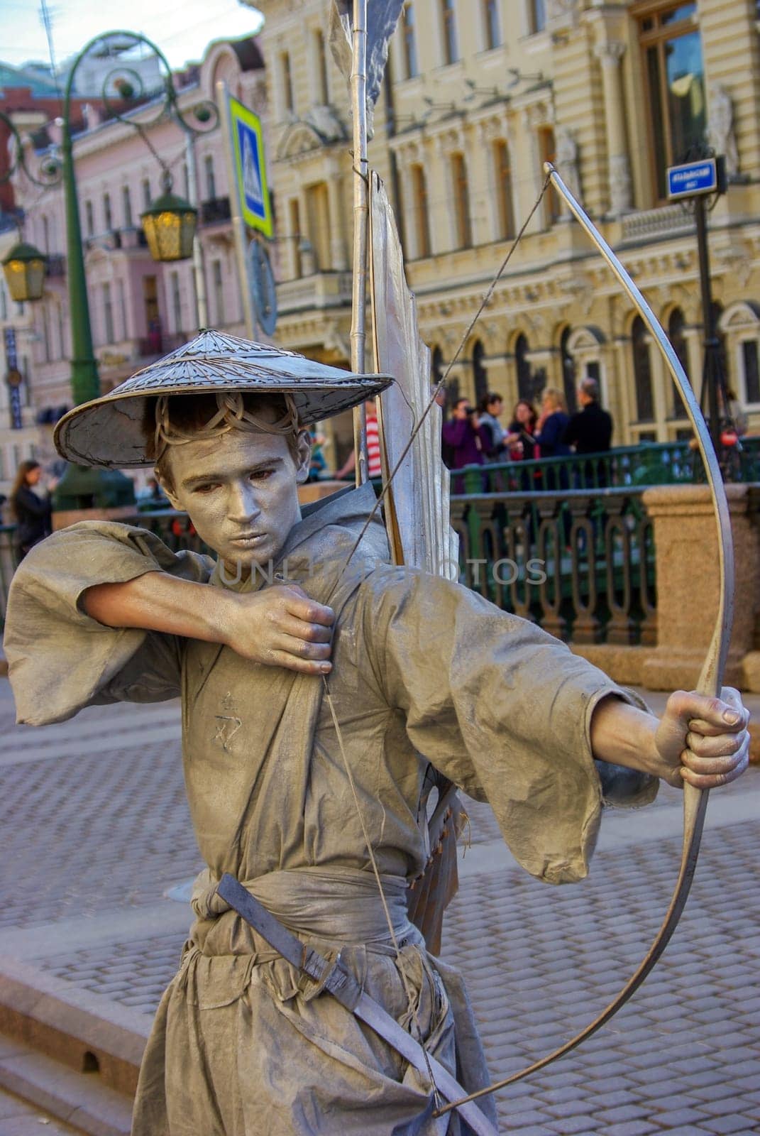 a performer - Silver painted artists on a city street, living statues