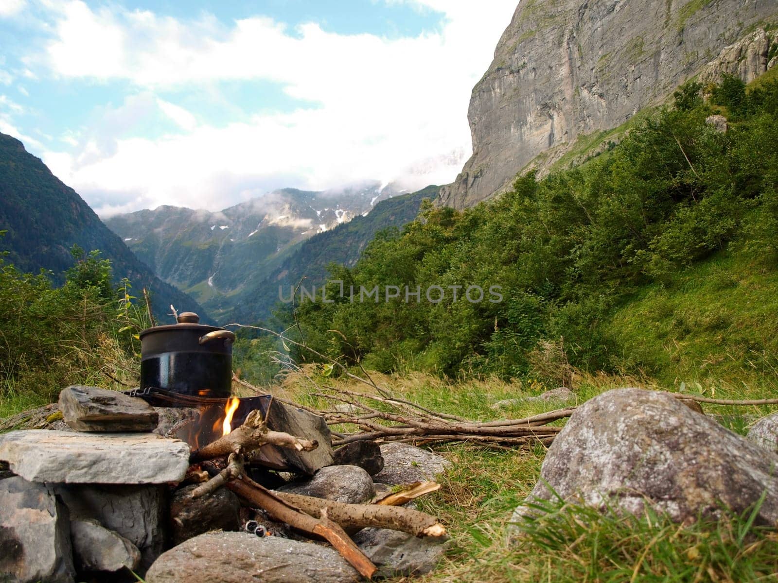 soup in a pot at fire place Summer trekking activity