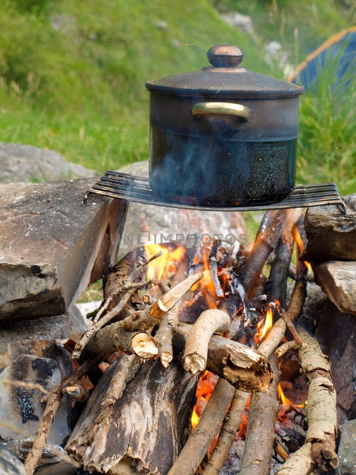 soup in a pot at fire place Summer trekking activity