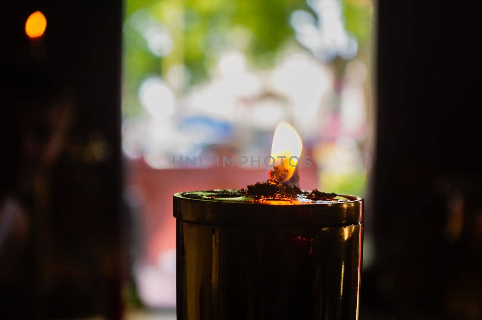 Burning oil lamps at religious temple in Thailand
