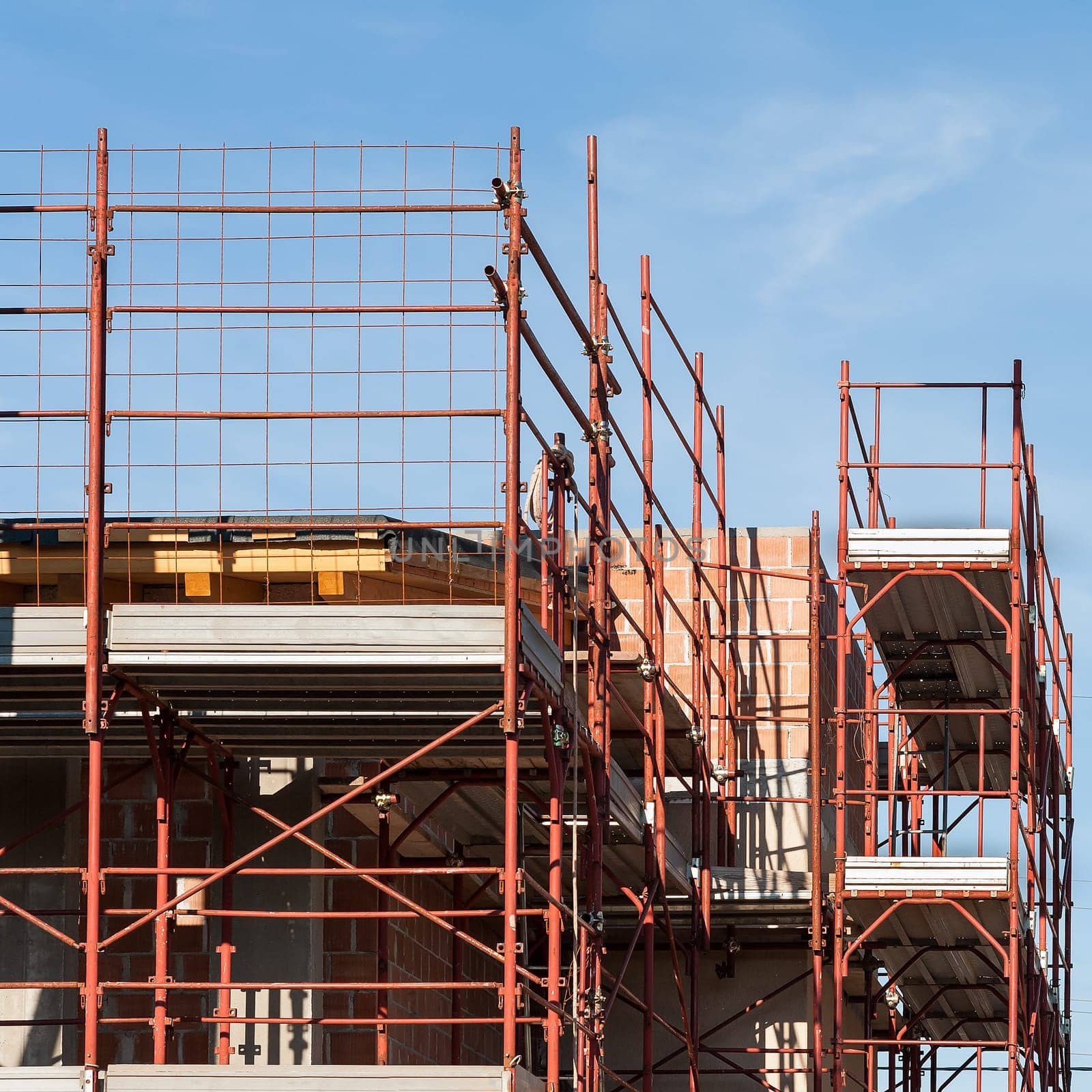 House under construction with the scaffolding for bricklayers