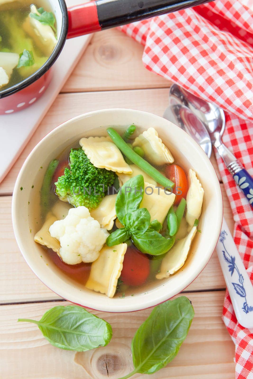 Rustic soup with fresh colorful vegetables