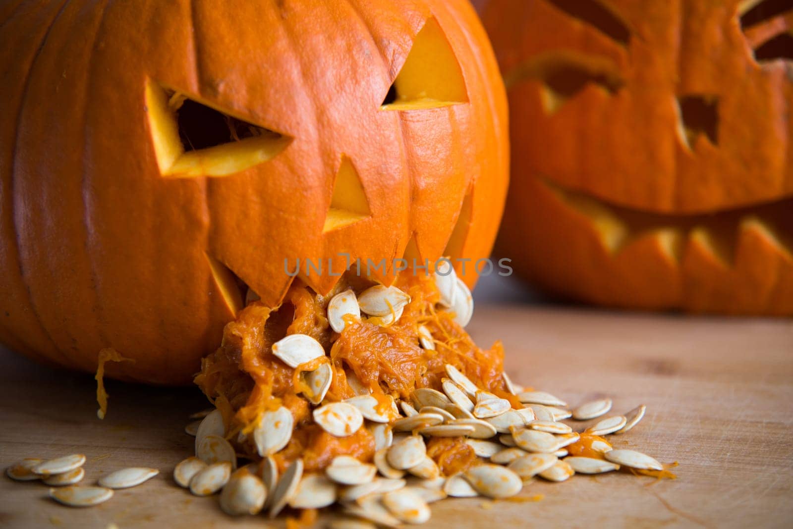 pumpkin puking with pumpkin seeds on wood table