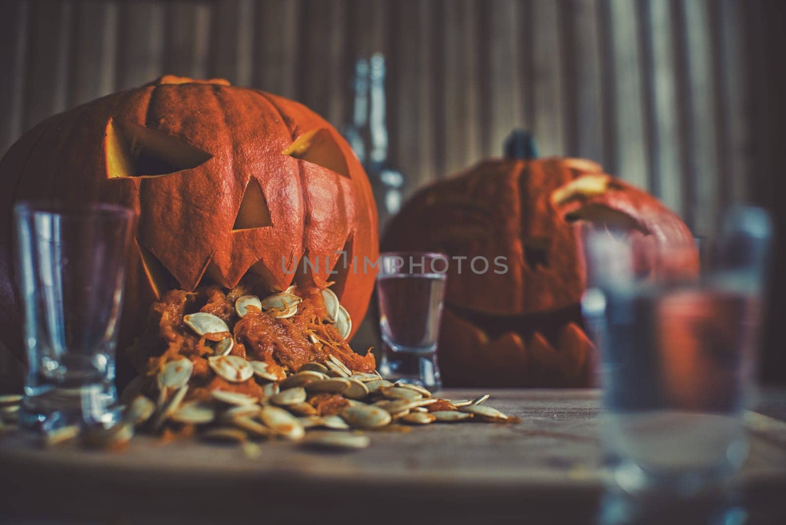  pumpkin puking with pumpkin seeds on wood table,vodka,hdr effect