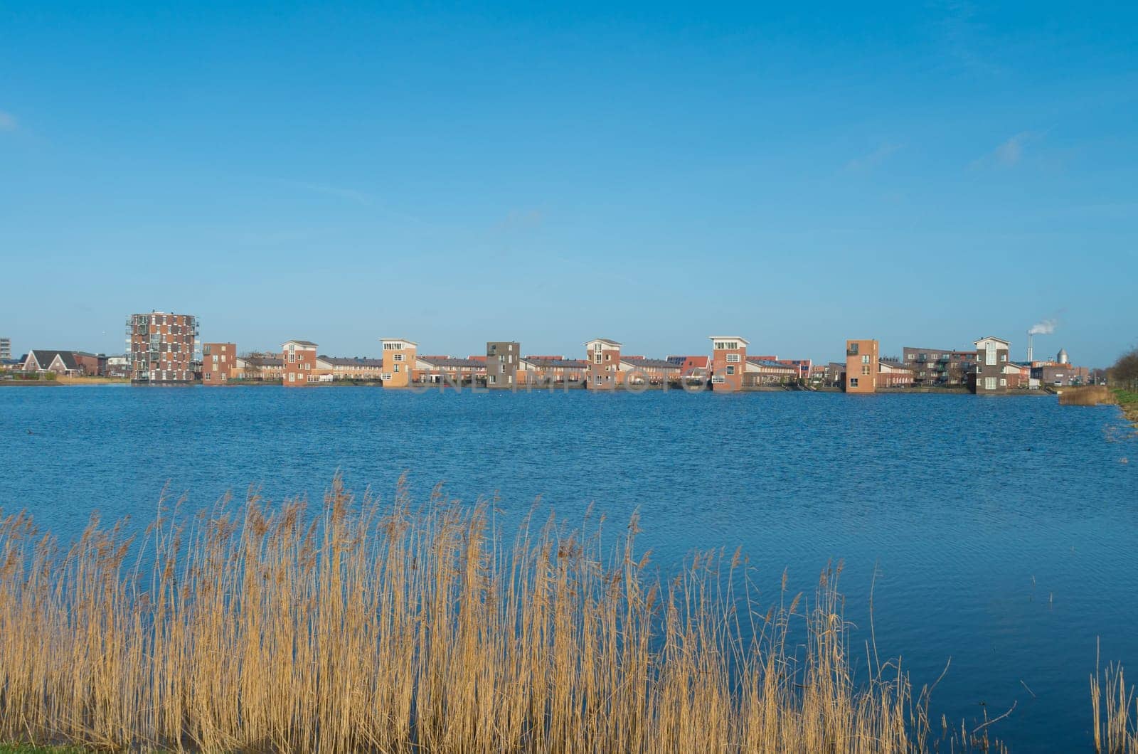 lakeside view of a newly build residential area in the netherlands