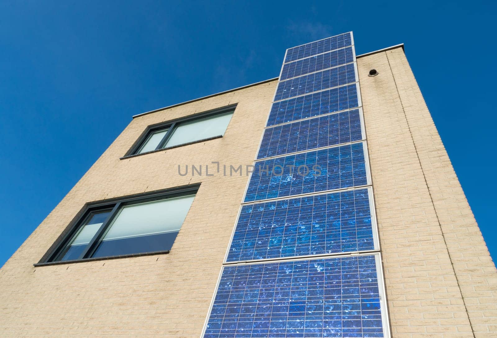 modern house in the netherlands with a row of solar panels at the its facade