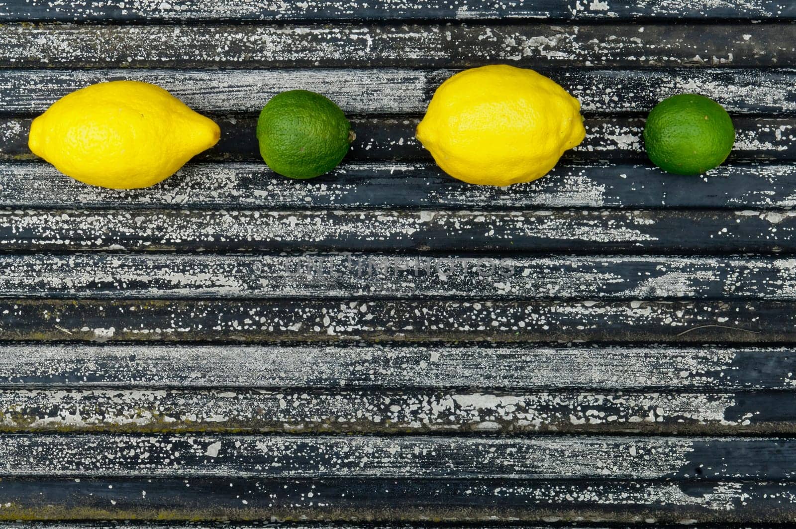 Raw textured black Background backdrop with lemon and lime and copy space outdoor