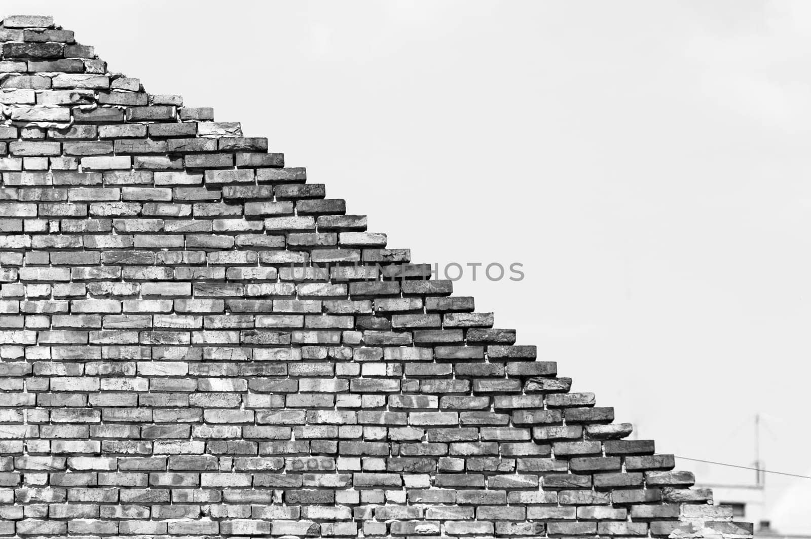 Textured old diagonal brick wall background,monochrome