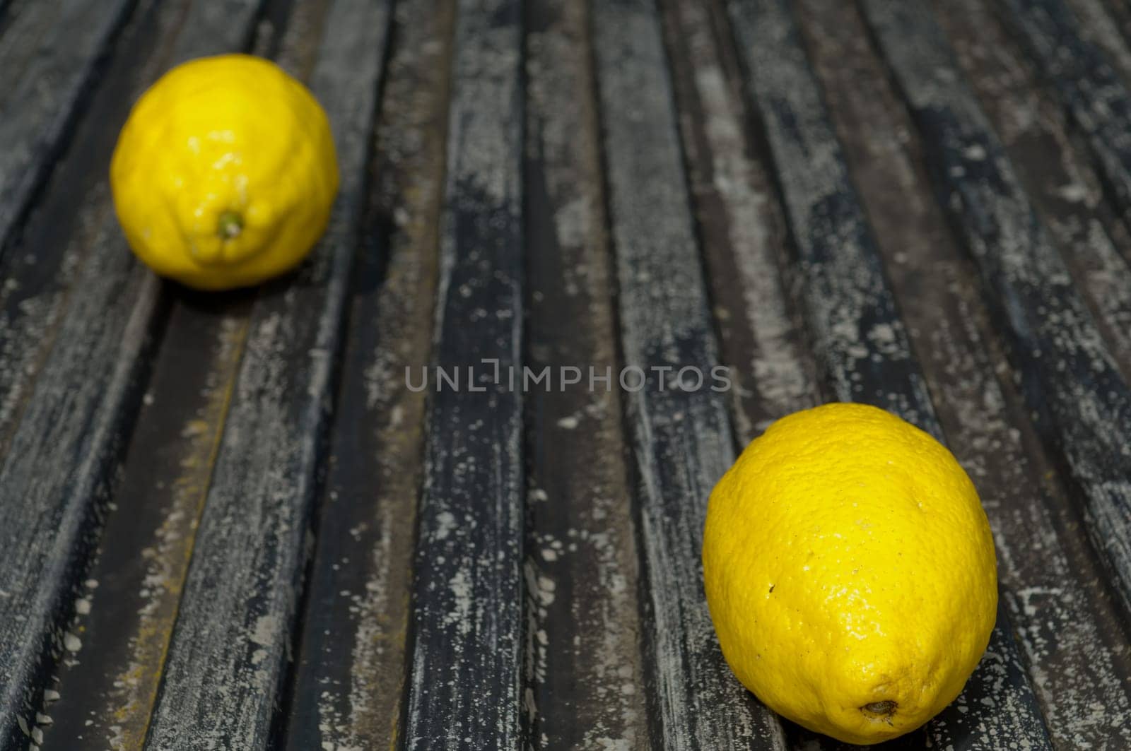 Raw textured black Background backdrop with lemon and lime and copy space outdoor